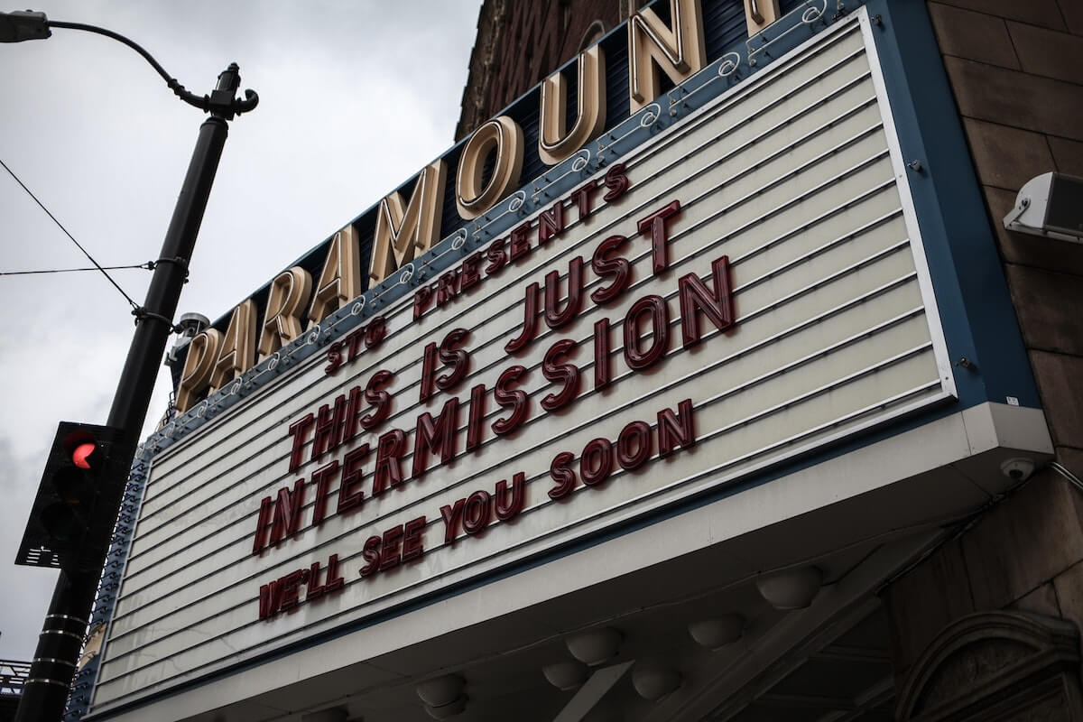 movie theater marquee with message that theater is temporarily closed and they'll see people again soon